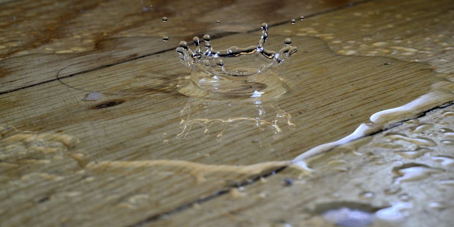 Water pooling on a hardwood floor after an indoor leak in a Houston home